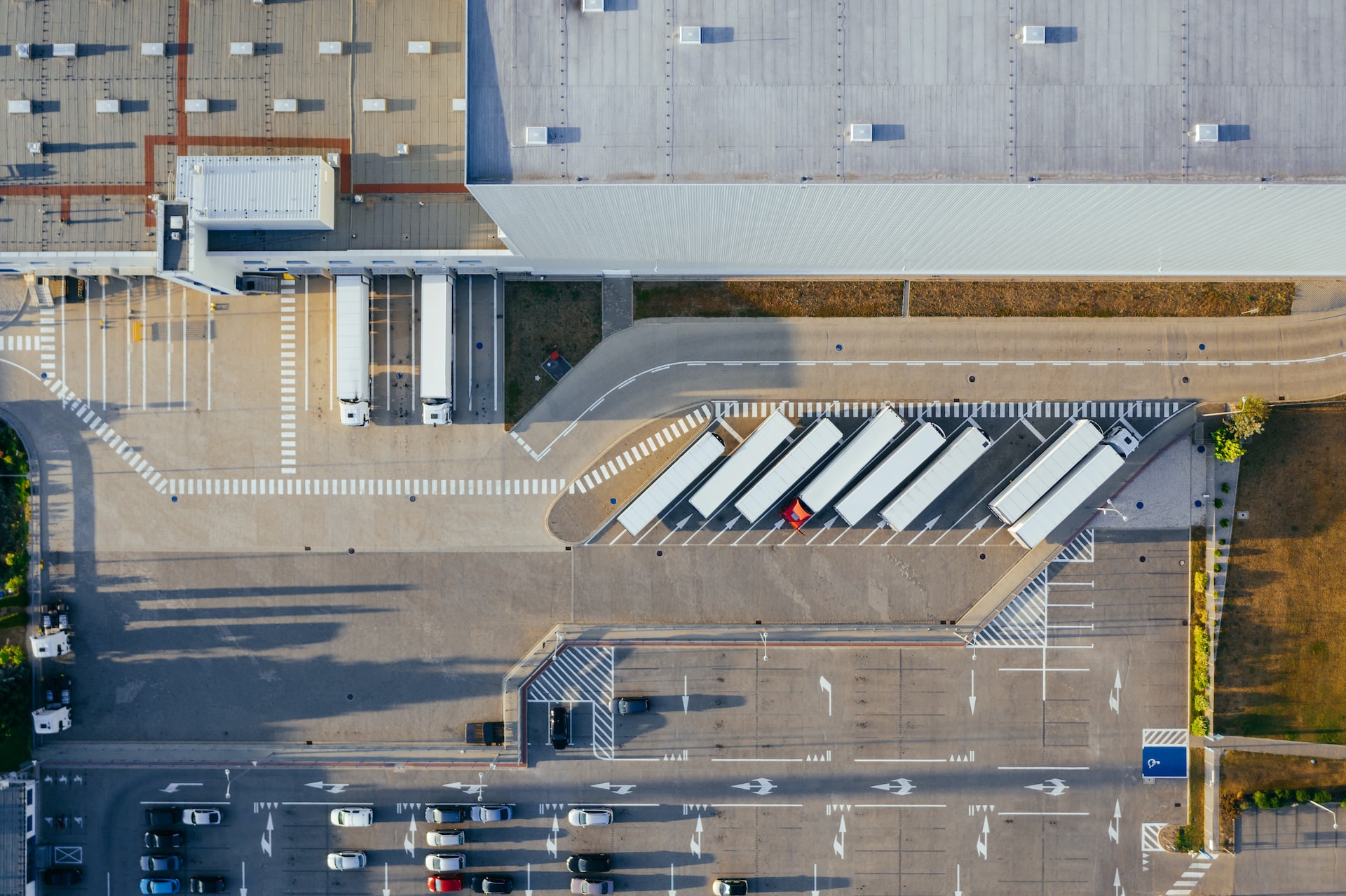 Overhead view of commercial warehouse with lorries parked up